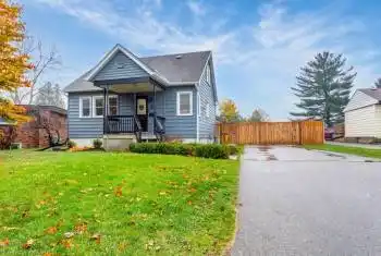 View of front of home with a porch and a front yard